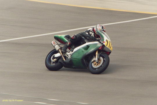 Green bike, outside shot of turn one